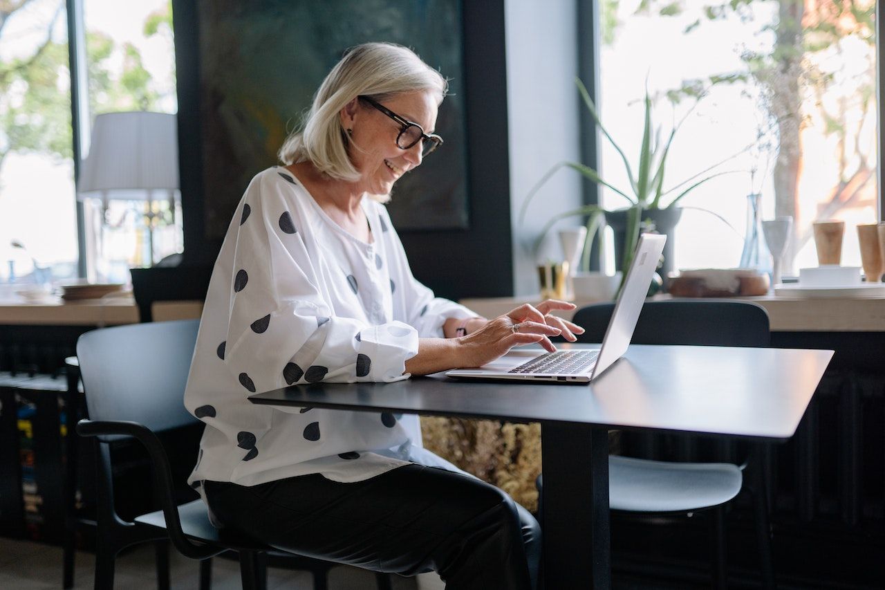 older woman on laptop roth conversion